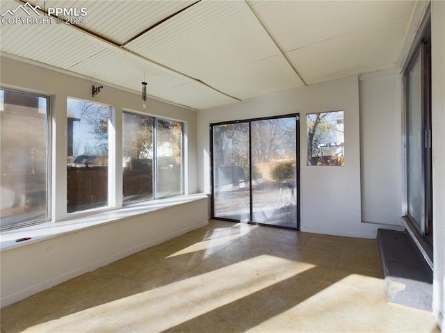 unfurnished sunroom featuring a wealth of natural light