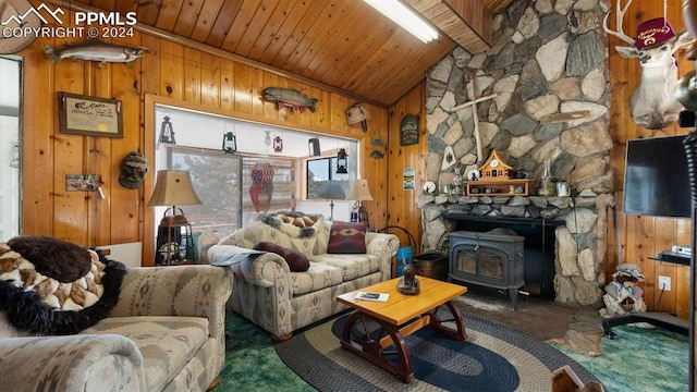 living room with wooden ceiling, a wood stove, wooden walls, vaulted ceiling, and carpet flooring