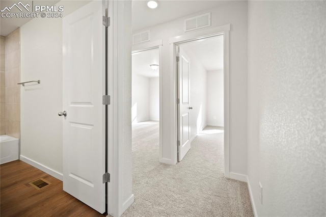 hallway with hardwood / wood-style floors