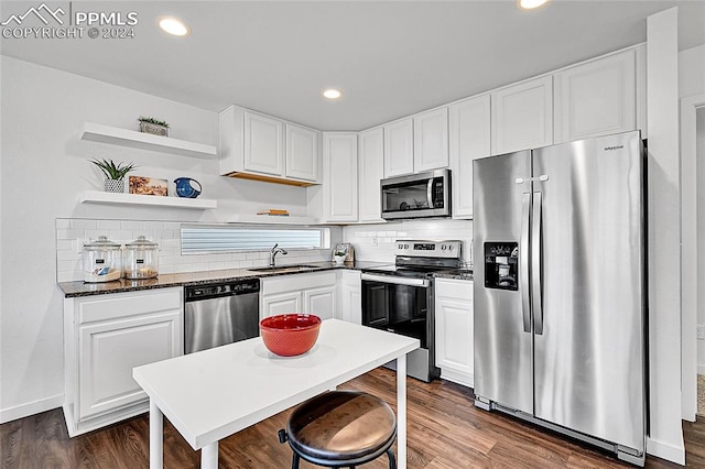 kitchen with white cabinets, dark hardwood / wood-style floors, sink, and appliances with stainless steel finishes