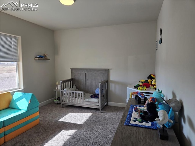 carpeted bedroom with a nursery area