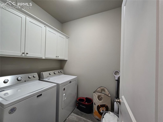 laundry room featuring separate washer and dryer, tile patterned flooring, and cabinets