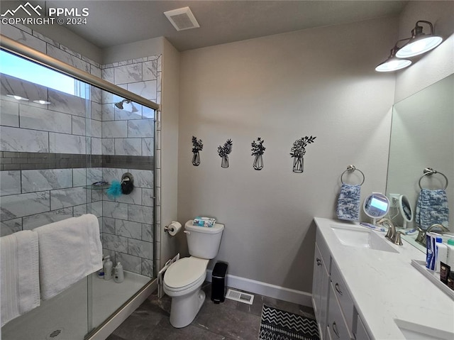 bathroom featuring vanity, toilet, and an enclosed shower