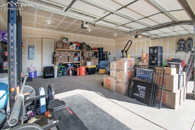 garage featuring electric panel and a garage door opener