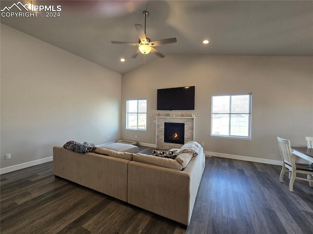 living room featuring a healthy amount of sunlight, dark wood-type flooring, ceiling fan, and lofted ceiling