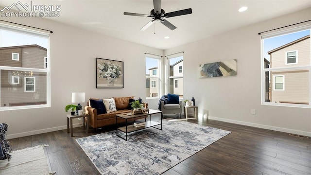 living room with dark hardwood / wood-style floors, a healthy amount of sunlight, and ceiling fan