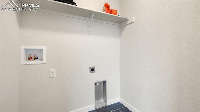 laundry area with dark tile patterned flooring, hookup for an electric dryer, and hookup for a washing machine