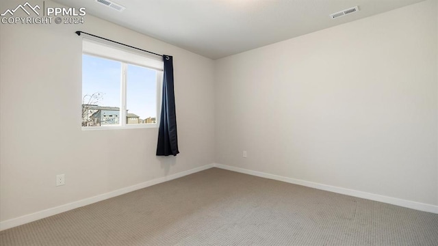 unfurnished room featuring carpet flooring