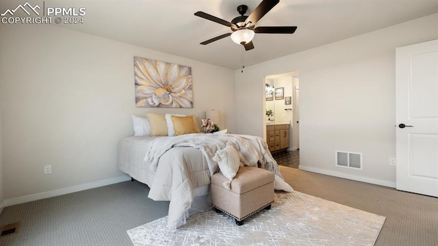 carpeted bedroom featuring ensuite bathroom and ceiling fan