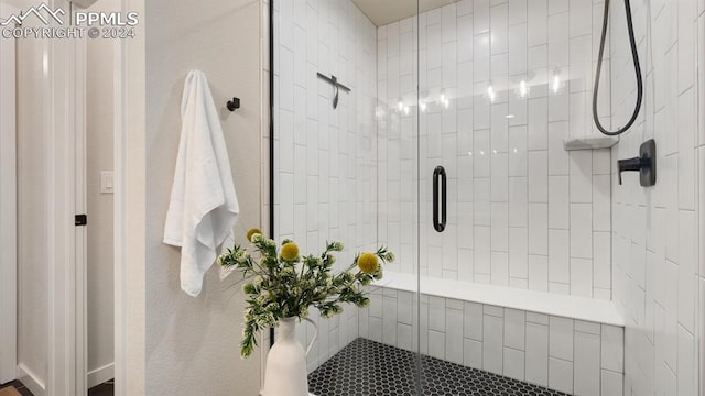 bathroom featuring a shower with door