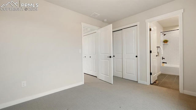 unfurnished bedroom featuring a closet and dark carpet