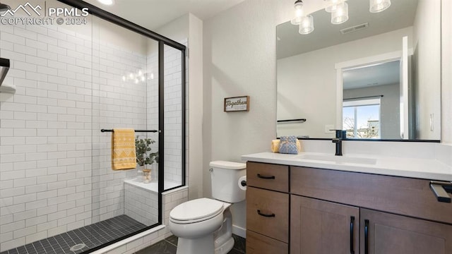 bathroom featuring vanity, toilet, and a shower with door