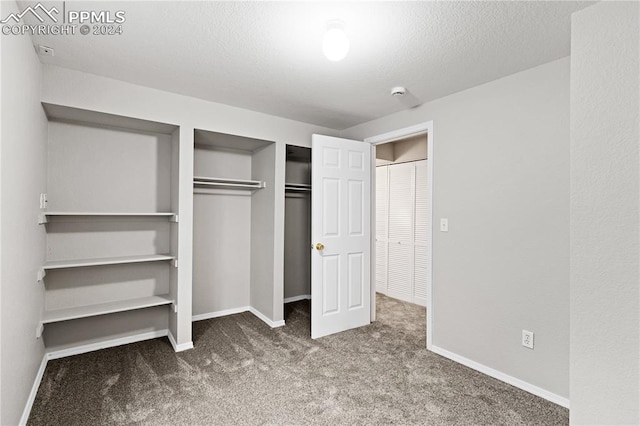 unfurnished bedroom with carpet and a textured ceiling