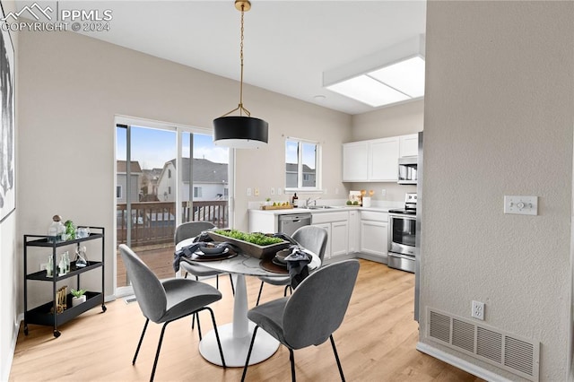 dining area featuring light hardwood / wood-style floors and sink