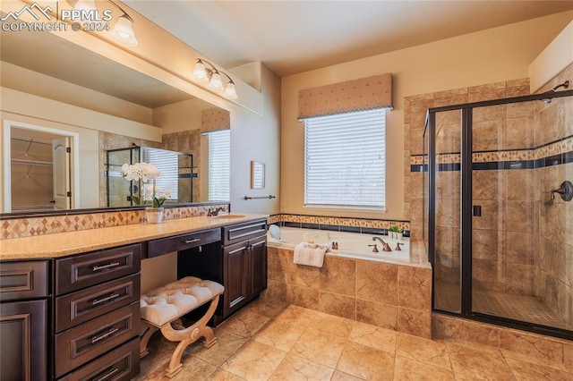 bathroom featuring tile patterned floors, vanity, and independent shower and bath