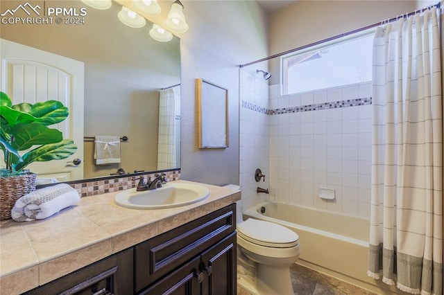 full bathroom featuring shower / bath combination with curtain, toilet, and vanity