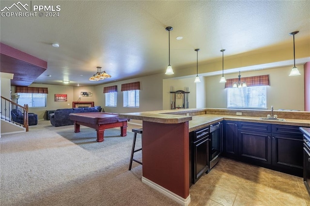 kitchen featuring a kitchen bar, light carpet, kitchen peninsula, pendant lighting, and pool table