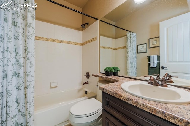 full bathroom featuring vanity, shower / bath combination with curtain, and toilet