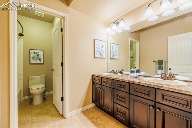 full bathroom featuring tile patterned floors, vanity, toilet, and shower / washtub combination