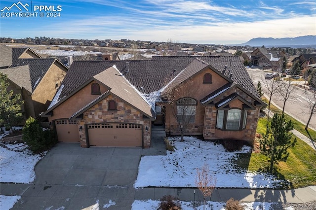 view of front of property with a mountain view and a garage