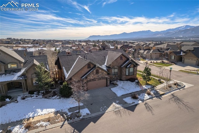 snowy aerial view with a mountain view