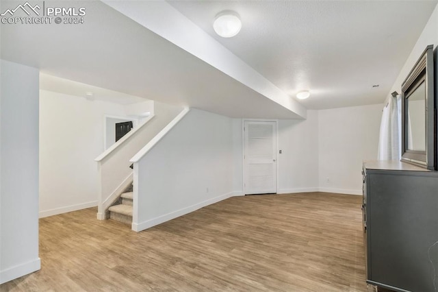 basement featuring light wood-type flooring