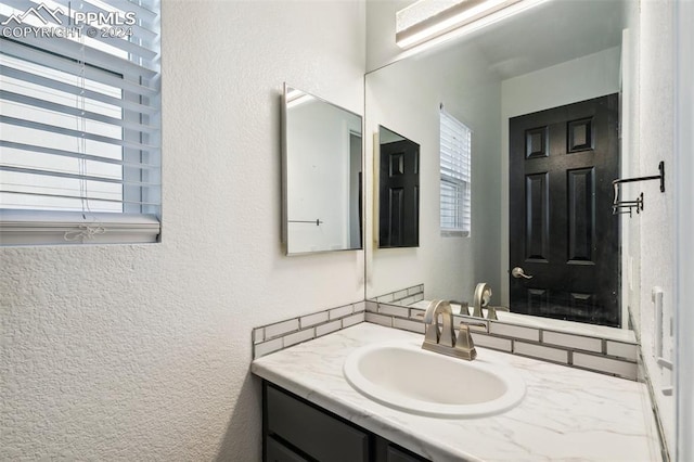 bathroom featuring vanity and a healthy amount of sunlight