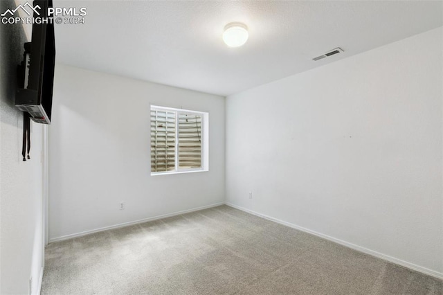 empty room featuring light colored carpet