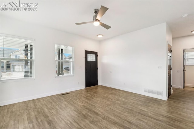 empty room with ceiling fan and wood-type flooring