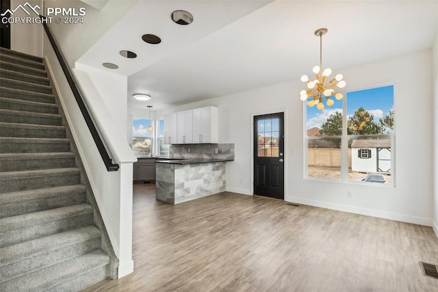 interior space featuring hardwood / wood-style floors and an inviting chandelier