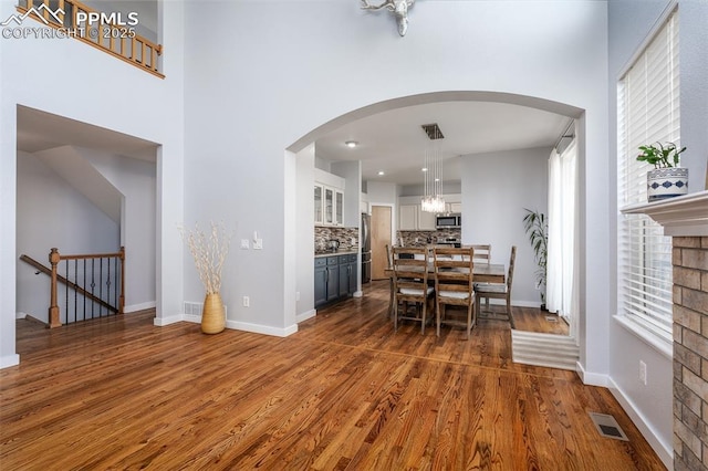 dining room with a fireplace and dark hardwood / wood-style floors