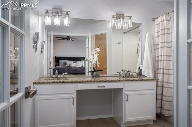 bathroom featuring curtained shower, ceiling fan, tile patterned flooring, and vanity