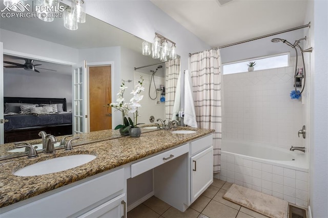 bathroom featuring tile patterned floors, ceiling fan, shower / tub combo with curtain, and vanity