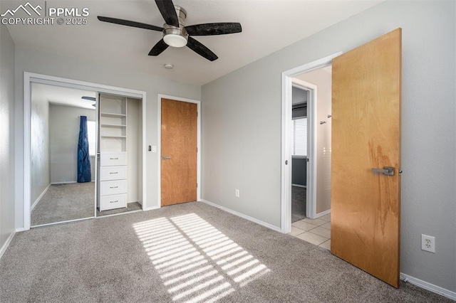 unfurnished bedroom featuring light carpet, a closet, and ceiling fan