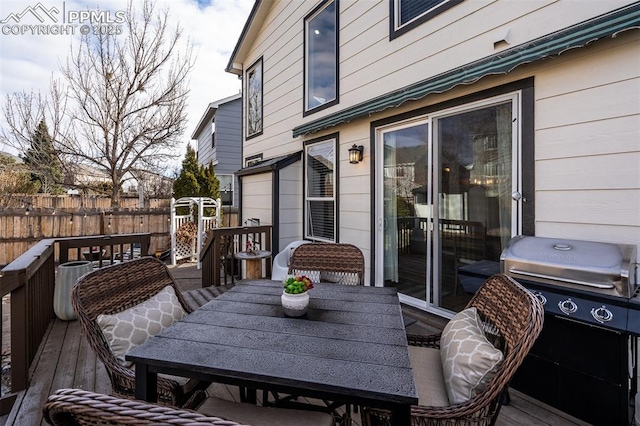 wooden terrace with a grill