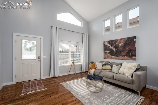 living room featuring dark hardwood / wood-style flooring and high vaulted ceiling