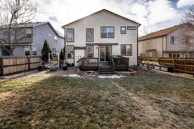 rear view of property with a lawn and a deck