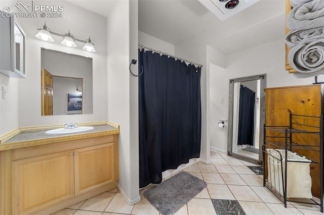 bathroom featuring curtained shower, tile patterned flooring, and vanity