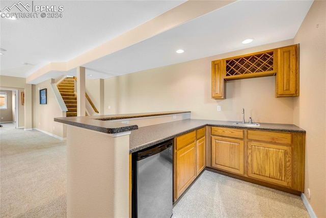 kitchen with dishwasher, light colored carpet, kitchen peninsula, and sink