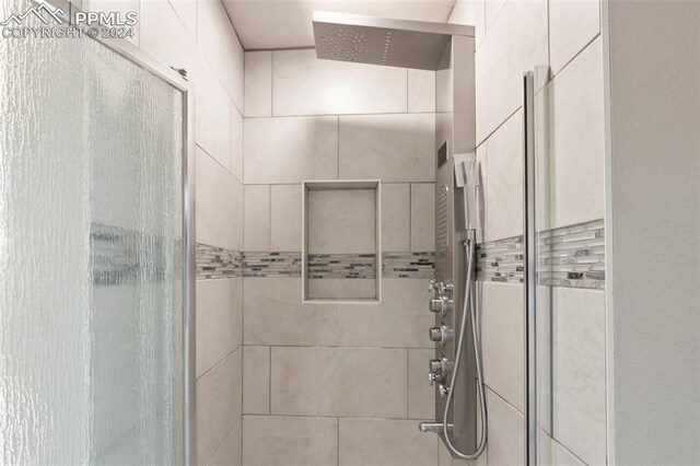 bathroom with a shower with door