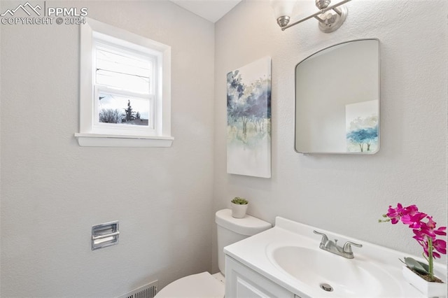 bathroom featuring vanity and toilet