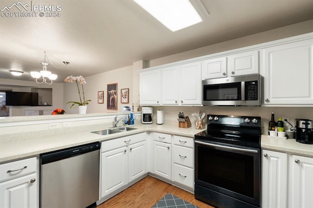 kitchen with sink, white cabinets, and stainless steel appliances