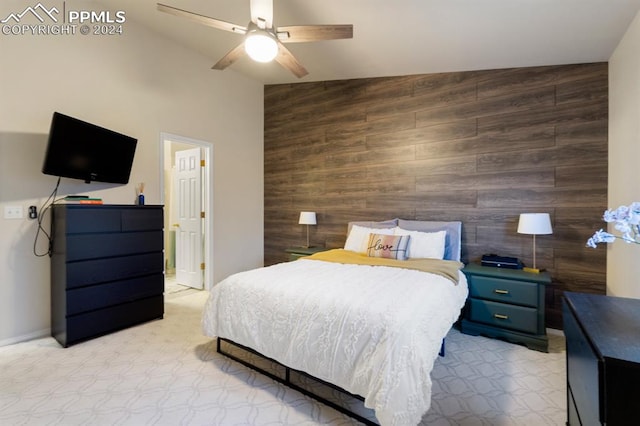 bedroom featuring wooden walls, ceiling fan, and lofted ceiling