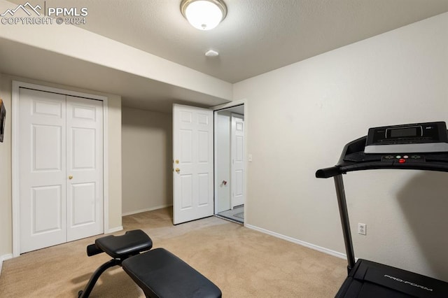 exercise room with light colored carpet