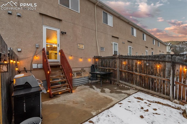 view of patio terrace at dusk