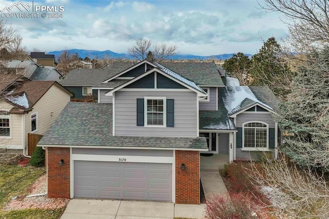 view of front facade featuring a mountain view and a garage