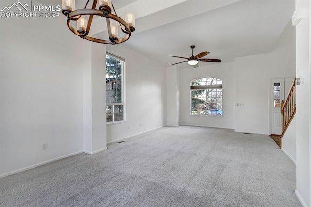 spare room with light colored carpet and ceiling fan with notable chandelier