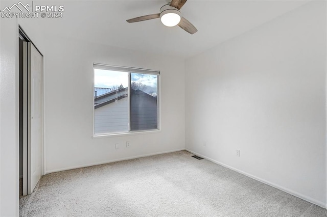 carpeted empty room with ceiling fan