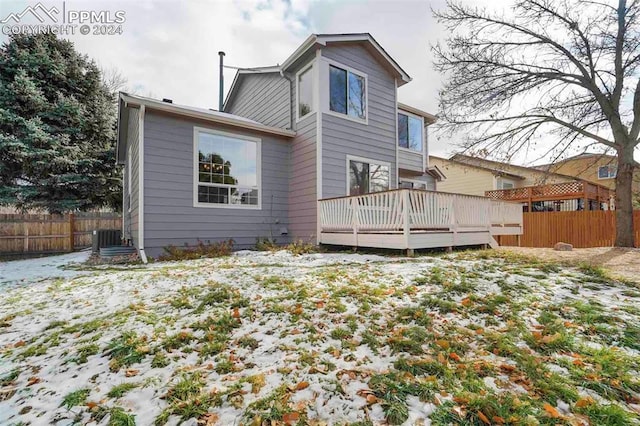 rear view of house featuring central AC unit and a deck