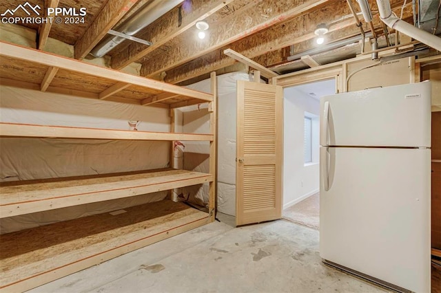 basement with white fridge